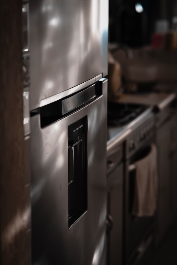 Appliance repair technician working in a Naples home